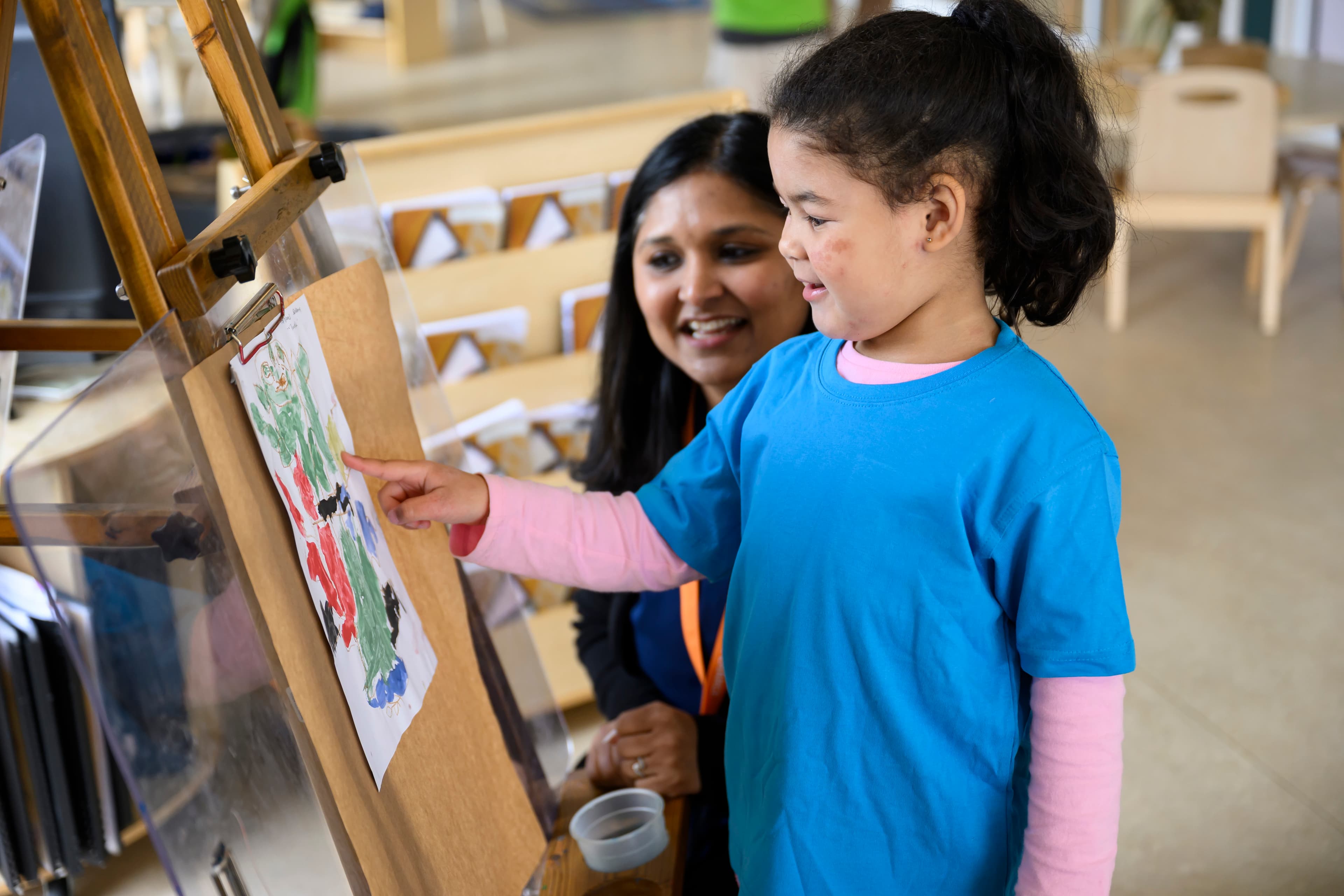 child at early childhood service painting