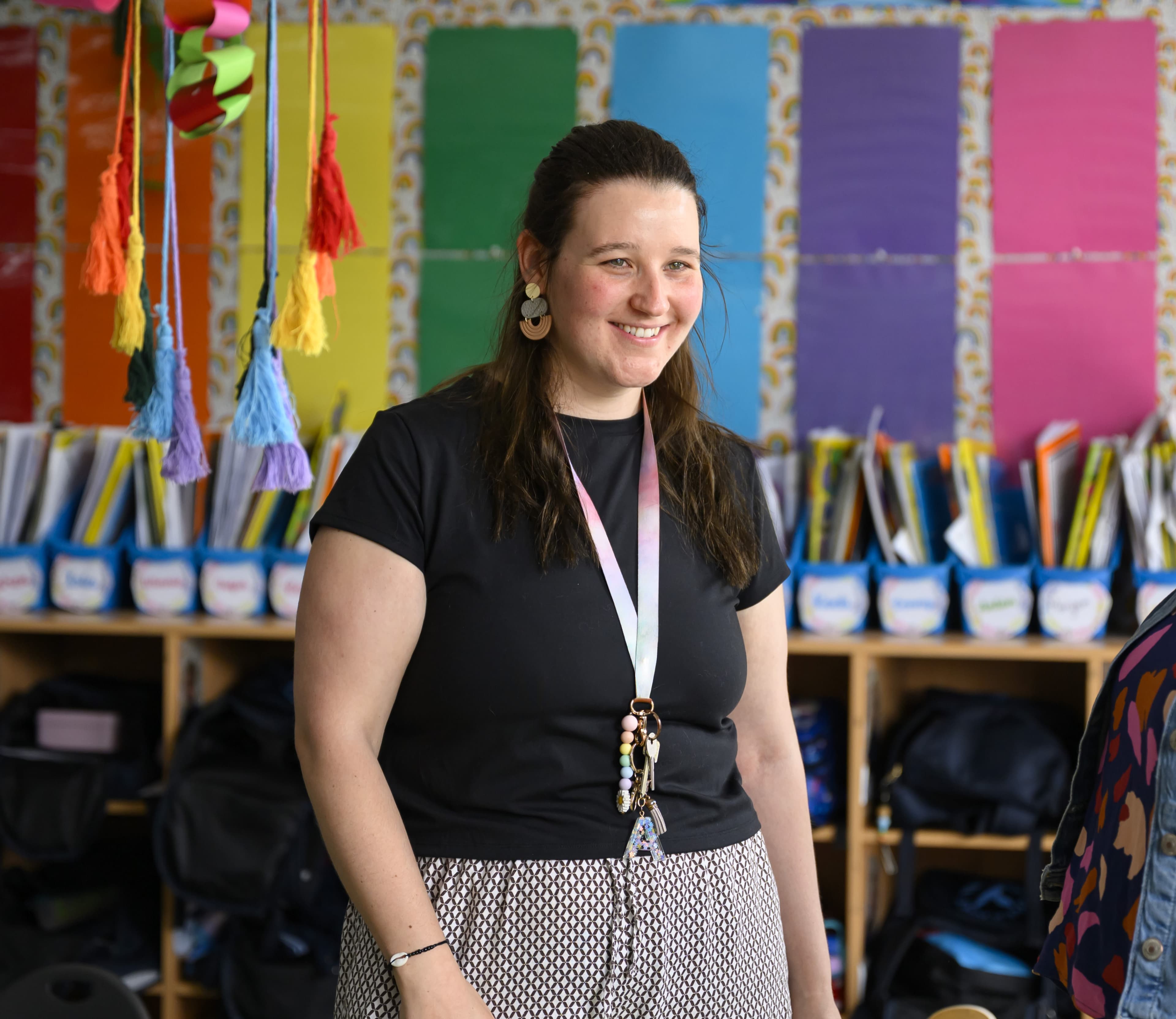 A teacher smiling in a classroom