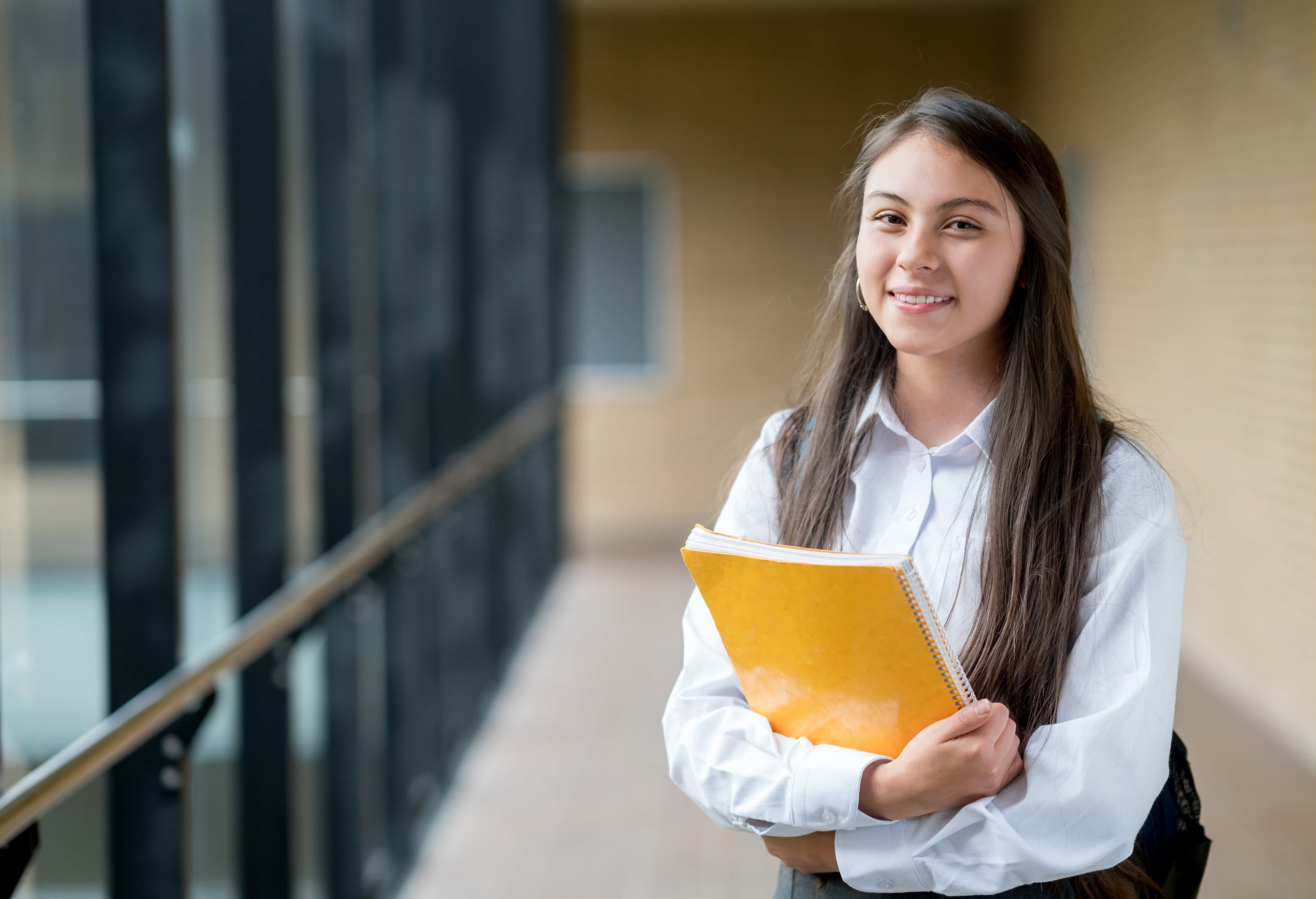 student in white shirt smiling